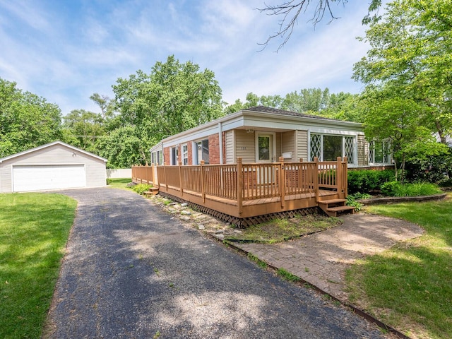566 Glendale Ave, Wheaton, IL 60137 - view of front of house featuring a garage, an outdoor structure, and a deck