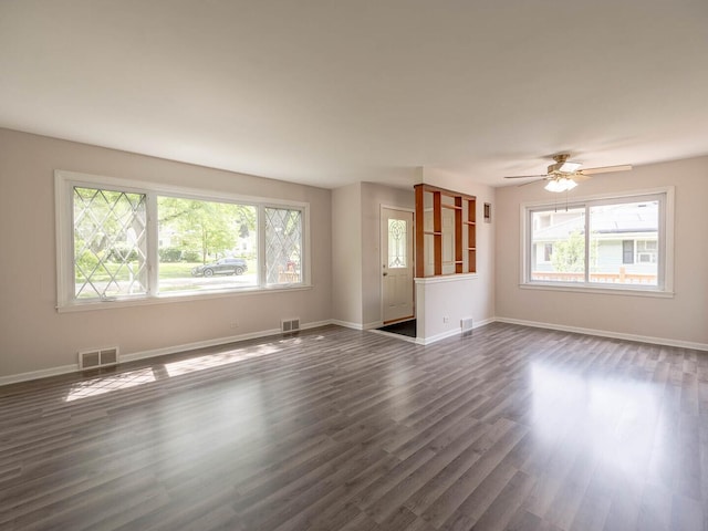 566 Glendale Ave, Wheaton, IL 60137 - unfurnished living room featuring plenty of natural light, dark wood finished floors, and ceiling fan
