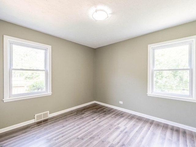 566 Glendale Ave, Wheaton, IL 60137 - spare room featuring plenty of natural light and wood finished floors