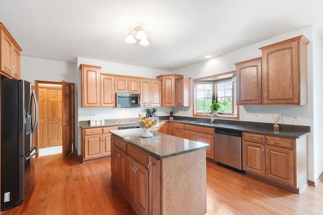 8025 Kirkcaldy Ct, Palos Heights, IL 60463 - kitchen featuring appliances with stainless steel finishes, light wood-style floors, a kitchen island, and dark stone counters