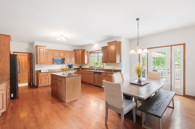 8025 Kirkcaldy Ct, Palos Heights, IL 60463 - kitchen with appliances with stainless steel finishes, a center island, light wood finished floors, pendant lighting, and a chandelier