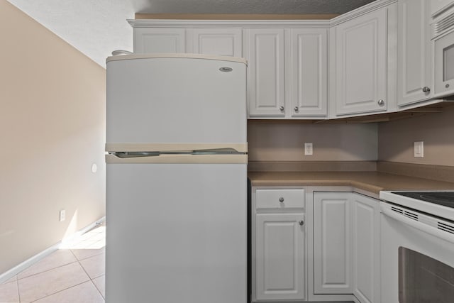 1610 Belclare Rd Unit 0, Normal, IL 61761 - kitchen with white appliances, white cabinets, and light tile patterned floors