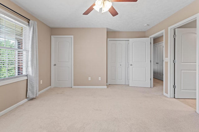 1610 Belclare Rd Unit 0, Normal, IL 61761 - unfurnished bedroom with light carpet, a closet, and a ceiling fan