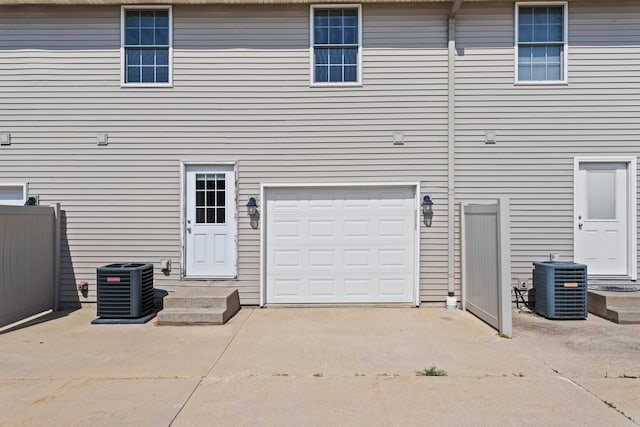 1610 Belclare Rd Unit 0, Normal, IL 61761 - back of house featuring a garage and concrete driveway