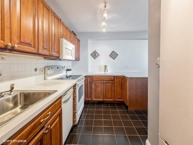 4250 N Marine Dr Unit 2607, Chicago, IL 60613 - kitchen with white appliances, brown cabinetry, dark tile patterned flooring, and rail lighting