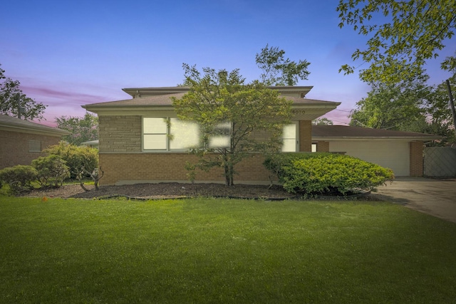 16030 University Ave, South Holland, IL 60473 - view of front of property with brick siding, a yard, an attached garage, and driveway