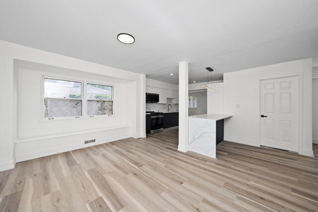 16030 University Ave, South Holland, IL 60473 - unfurnished living room featuring light wood-style flooring