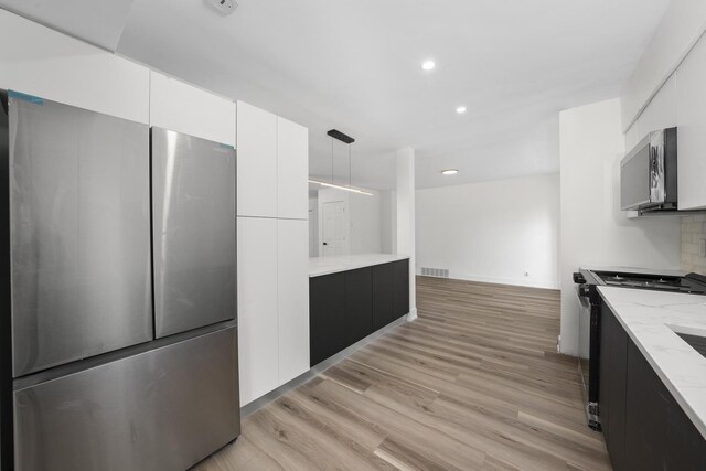 16030 University Ave, South Holland, IL 60473 - kitchen with black range, modern cabinets, freestanding refrigerator, light stone countertops, and recessed lighting
