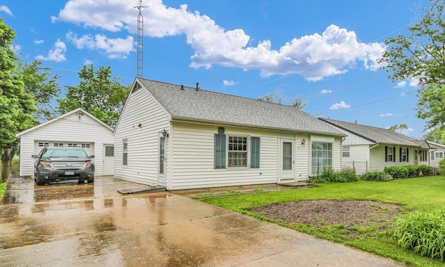 907 E Glenview Dr, Tuscola, IL 61953 - view of front of house with an outbuilding, concrete driveway, a front lawn, a garage, and roof with shingles
