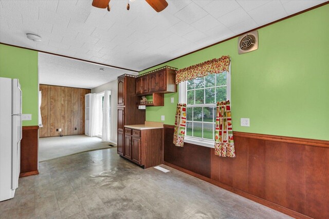 907 E Glenview Dr, Tuscola, IL 61953 - kitchen featuring wood walls, freestanding refrigerator, ceiling fan, light countertops, and a wainscoted wall