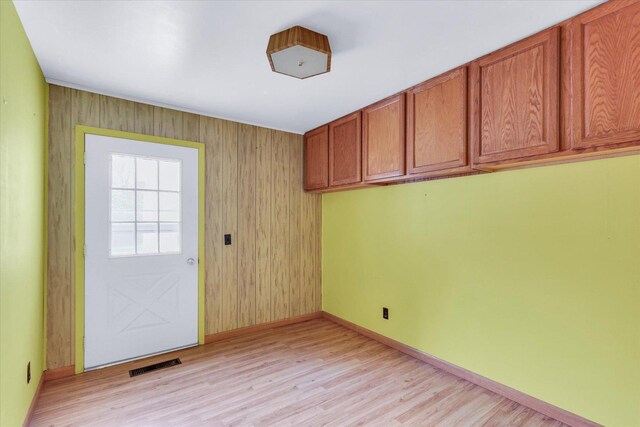 907 E Glenview Dr, Tuscola, IL 61953 - doorway featuring light wood finished floors and wood walls