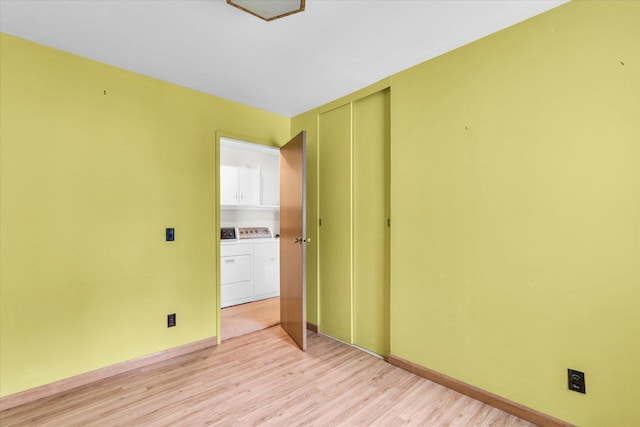 907 E Glenview Dr, Tuscola, IL 61953 - unfurnished room with light wood-type flooring and washing machine and dryer
