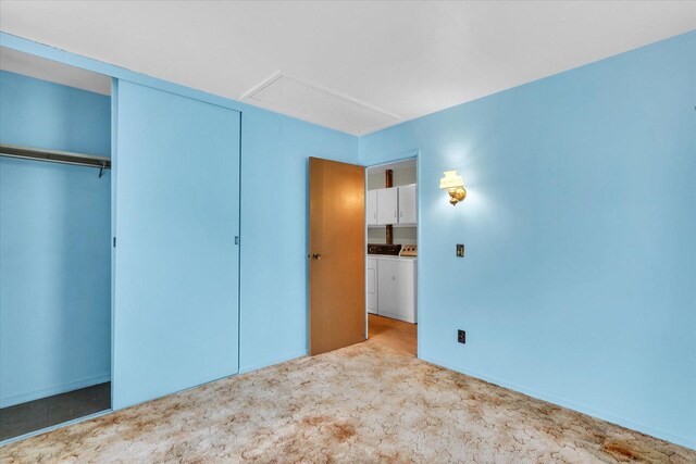 907 E Glenview Dr, Tuscola, IL 61953 - unfurnished bedroom featuring washing machine and dryer, attic access, carpet floors, and a closet
