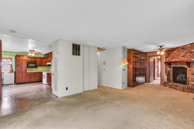 907 E Glenview Dr, Tuscola, IL 61953 - unfurnished living room with ceiling fan, a textured ceiling, a fireplace, and light carpet