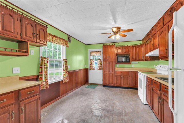 907 E Glenview Dr, Tuscola, IL 61953 - kitchen with white appliances, under cabinet range hood, wainscoting, ceiling fan, and light countertops