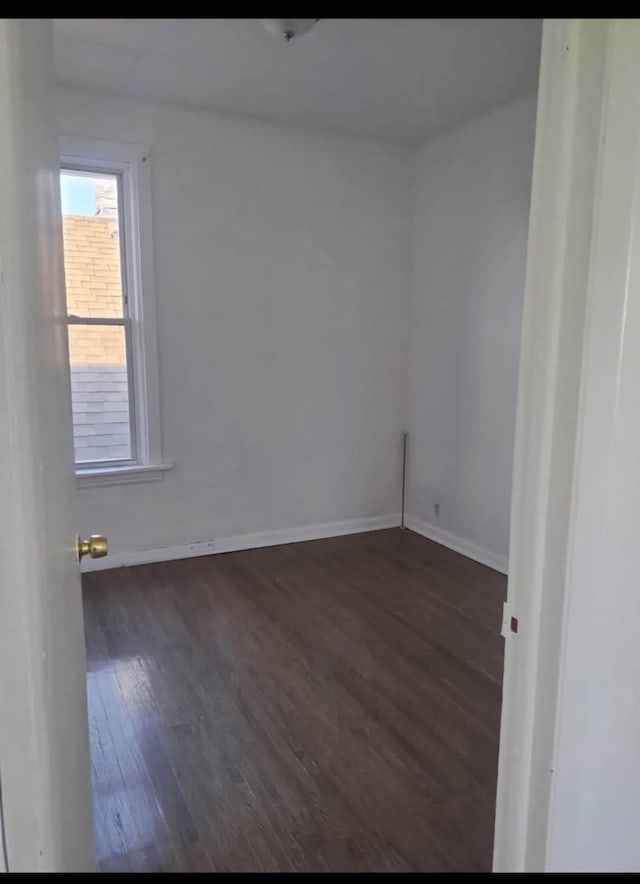 7759 S Kingston Ave Unit 1S, Chicago, IL 60649 - spare room with dark wood-type flooring and baseboards