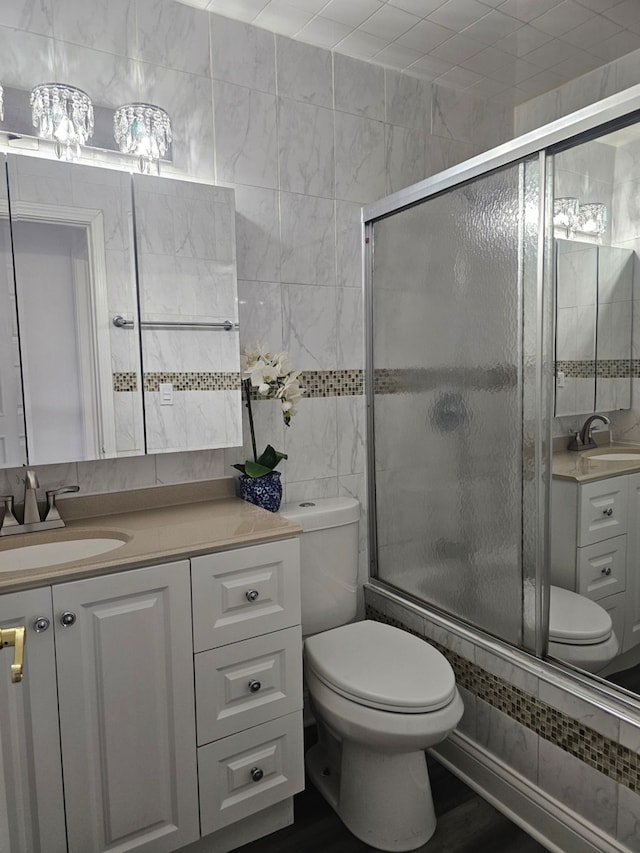 419 Sidney Ave Unit A, Glendale Heights, IL 60139 - bathroom with vanity, tile walls, and wood finished floors