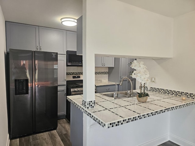 419 Sidney Ave Unit A, Glendale Heights, IL 60139 - kitchen with refrigerator with ice dispenser, black microwave, gray cabinetry, and dark wood-style flooring