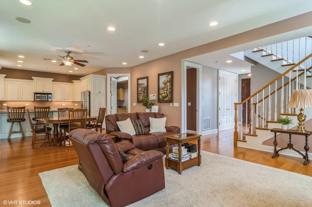 706 French Way Unit 2, Mount Prospect, IL 60056 - living area with light wood-type flooring, a ceiling fan, stairs, and recessed lighting