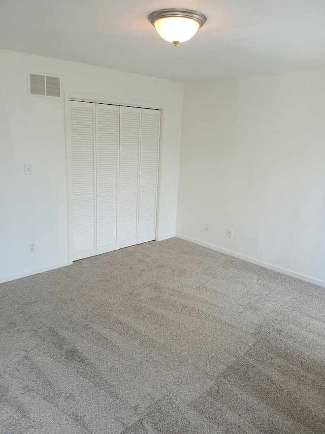 313 Manning Dr, Dekalb, IL 60115 - unfurnished bedroom featuring carpet floors and a closet