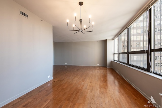 400 E Ohio St Unit 2302, Chicago, IL 60611 - spare room with a chandelier, light wood-type flooring, and plenty of natural light