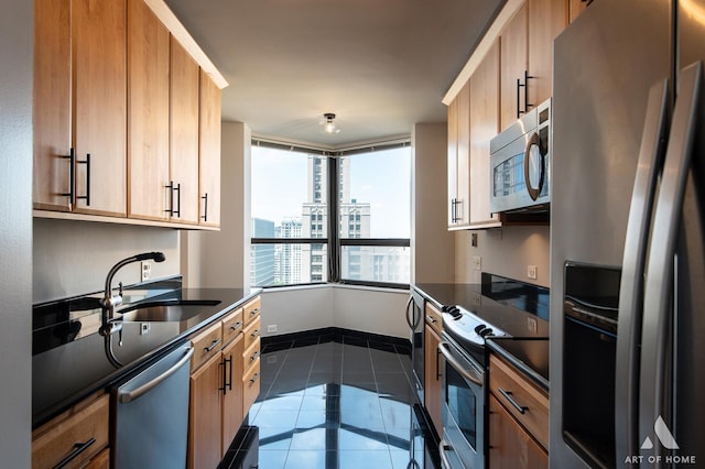 400 E Ohio St Unit 2302, Chicago, IL 60611 - kitchen featuring appliances with stainless steel finishes, dark countertops, dark tile patterned flooring, a city view, and light brown cabinets