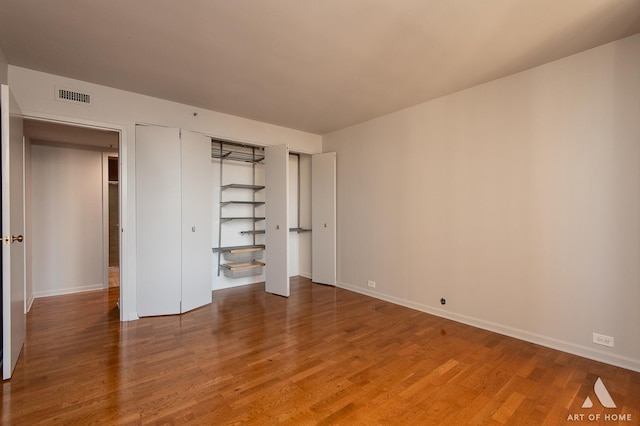 400 E Ohio St Unit 2302, Chicago, IL 60611 - unfurnished bedroom with wood finished floors and a closet