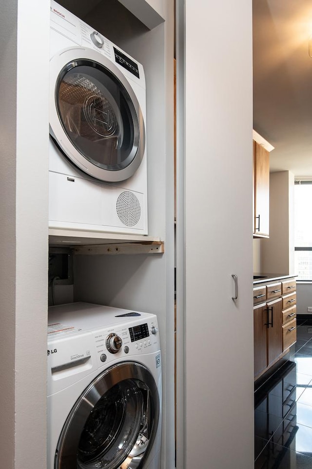 400 E Ohio St Unit 2302, Chicago, IL 60611 - laundry area with stacked washer / drying machine and dark tile patterned floors