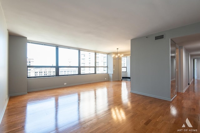 400 E Ohio St Unit 2302, Chicago, IL 60611 - unfurnished room featuring a chandelier and wood finished floors