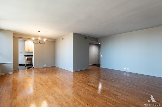 400 E Ohio St Unit 2302, Chicago, IL 60611 - unfurnished living room featuring a chandelier and light wood-style floors