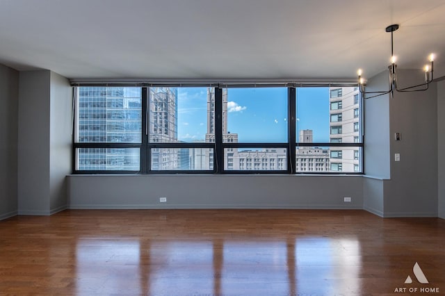 400 E Ohio St Unit 2302, Chicago, IL 60611 - unfurnished room with wood finished floors, a view of city, and a chandelier