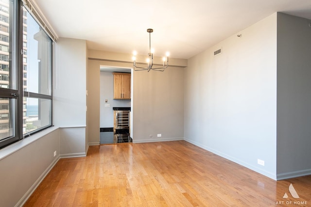 400 E Ohio St Unit 2302, Chicago, IL 60611 - unfurnished dining area featuring light wood-type flooring and a chandelier
