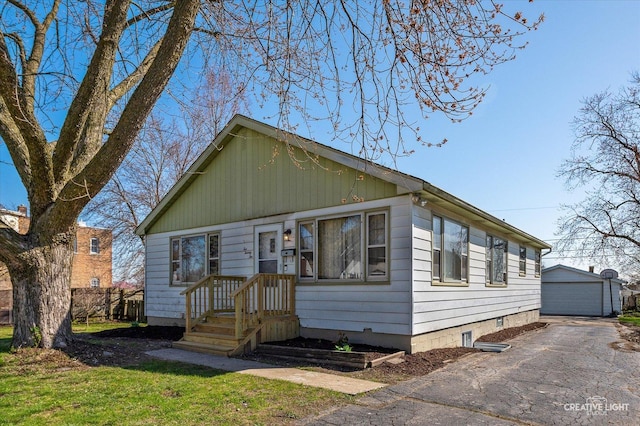 1022 Cora St, Joliet, IL 60435 - bungalow-style house with a detached garage, an outdoor structure, and a front yard