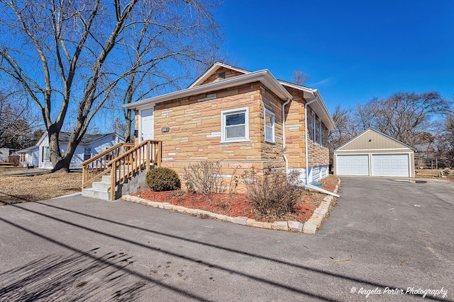 208 W Nippersink Rd, Round Lake, IL 60073 - view of side of home featuring stone siding, a garage, and an outbuilding
