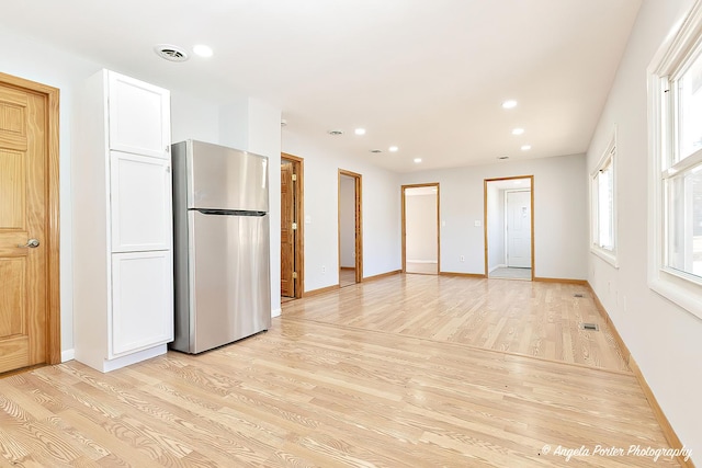 208 W Nippersink Rd, Round Lake, IL 60073 - kitchen featuring freestanding refrigerator, light wood-style flooring, white cabinetry, and recessed lighting