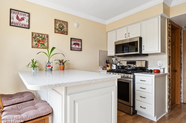 7330 Winthrop Way Unit 2, Downers Grove, IL 60515 - kitchen with stainless steel appliances, ornamental molding, a kitchen breakfast bar, tasteful backsplash, and white cabinetry