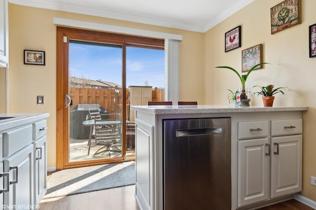 7330 Winthrop Way Unit 2, Downers Grove, IL 60515 - kitchen with ornamental molding, wood finished floors, light countertops, stainless steel dishwasher, and white cabinets