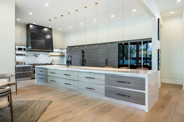 2110 Pfingsten Rd, Northbrook, IL 60062 - kitchen featuring modern cabinets, exhaust hood, light wood finished floors, backsplash, and recessed lighting