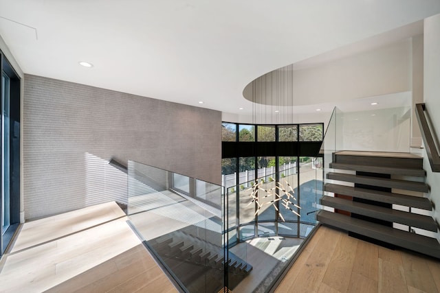 2110 Pfingsten Rd, Northbrook, IL 60062 - stairs featuring hardwood / wood-style floors, an accent wall, and recessed lighting