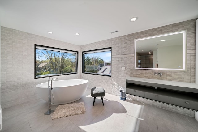 2110 Pfingsten Rd, Northbrook, IL 60062 - bathroom with tile walls, tile patterned flooring, vanity, a freestanding tub, and recessed lighting