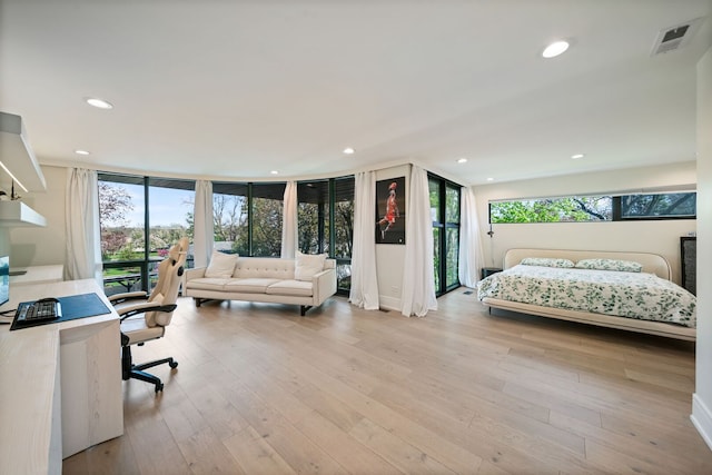 2110 Pfingsten Rd, Northbrook, IL 60062 - bedroom with an office area, light wood-type flooring, recessed lighting, and a wall of windows