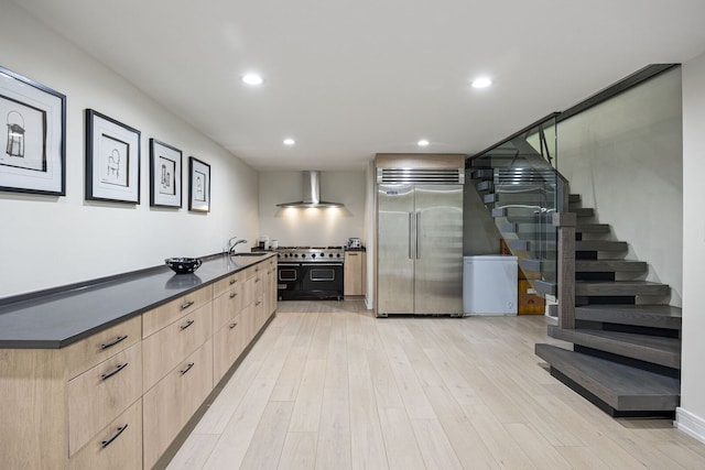 2110 Pfingsten Rd, Northbrook, IL 60062 - kitchen with high end appliances, light brown cabinetry, wall chimney exhaust hood, modern cabinets, and dark countertops