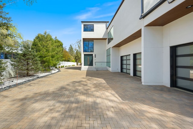 2110 Pfingsten Rd, Northbrook, IL 60062 - view of patio featuring an attached garage and decorative driveway