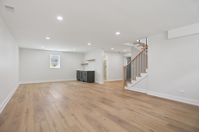 5041 N Octavia Ave, Harwood Heights, IL 60706 - unfurnished living room with stairs, light wood-style floors, and recessed lighting