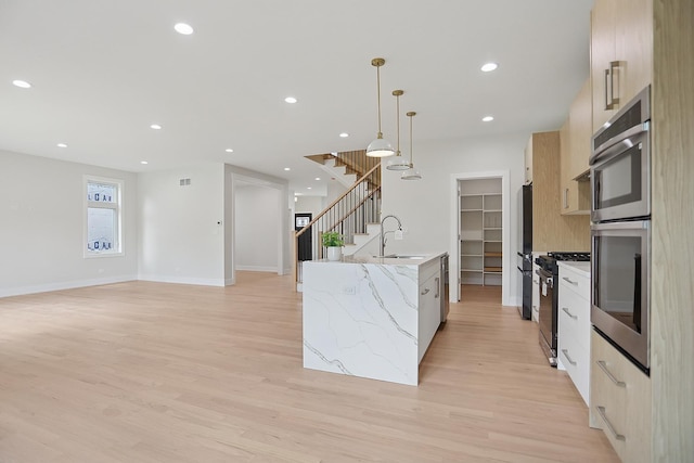 5041 N Octavia Ave, Harwood Heights, IL 60706 - kitchen with black range with gas cooktop, freestanding refrigerator, modern cabinets, light wood finished floors, and recessed lighting