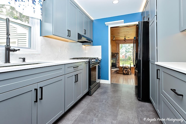 482 S Alfred Ave, Elgin, IL 60123 - kitchen with stainless steel gas range oven, gray cabinetry, freestanding refrigerator, light countertops, and recessed lighting