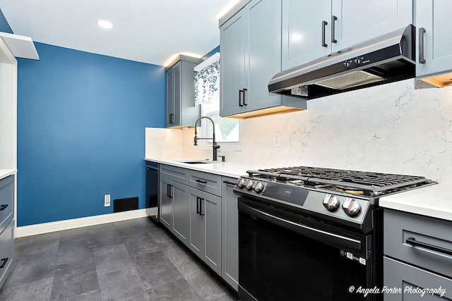 482 S Alfred Ave, Elgin, IL 60123 - kitchen featuring stainless steel gas range, under cabinet range hood, backsplash, gray cabinets, and recessed lighting