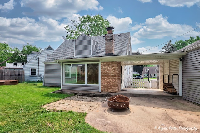 482 S Alfred Ave, Elgin, IL 60123 - back of property with a patio, an outdoor fire pit, a chimney, and brick siding