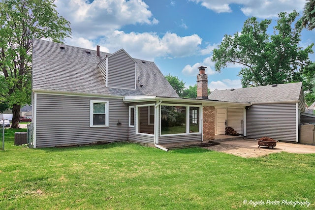 482 S Alfred Ave, Elgin, IL 60123 - rear view of property with a fire pit, a chimney, a patio area, and a lawn