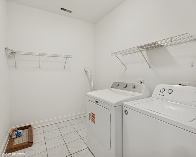 506 W Oakdale Ave Unit 1, Chicago, IL 60657 - laundry room featuring light marble finish floors and washer and dryer